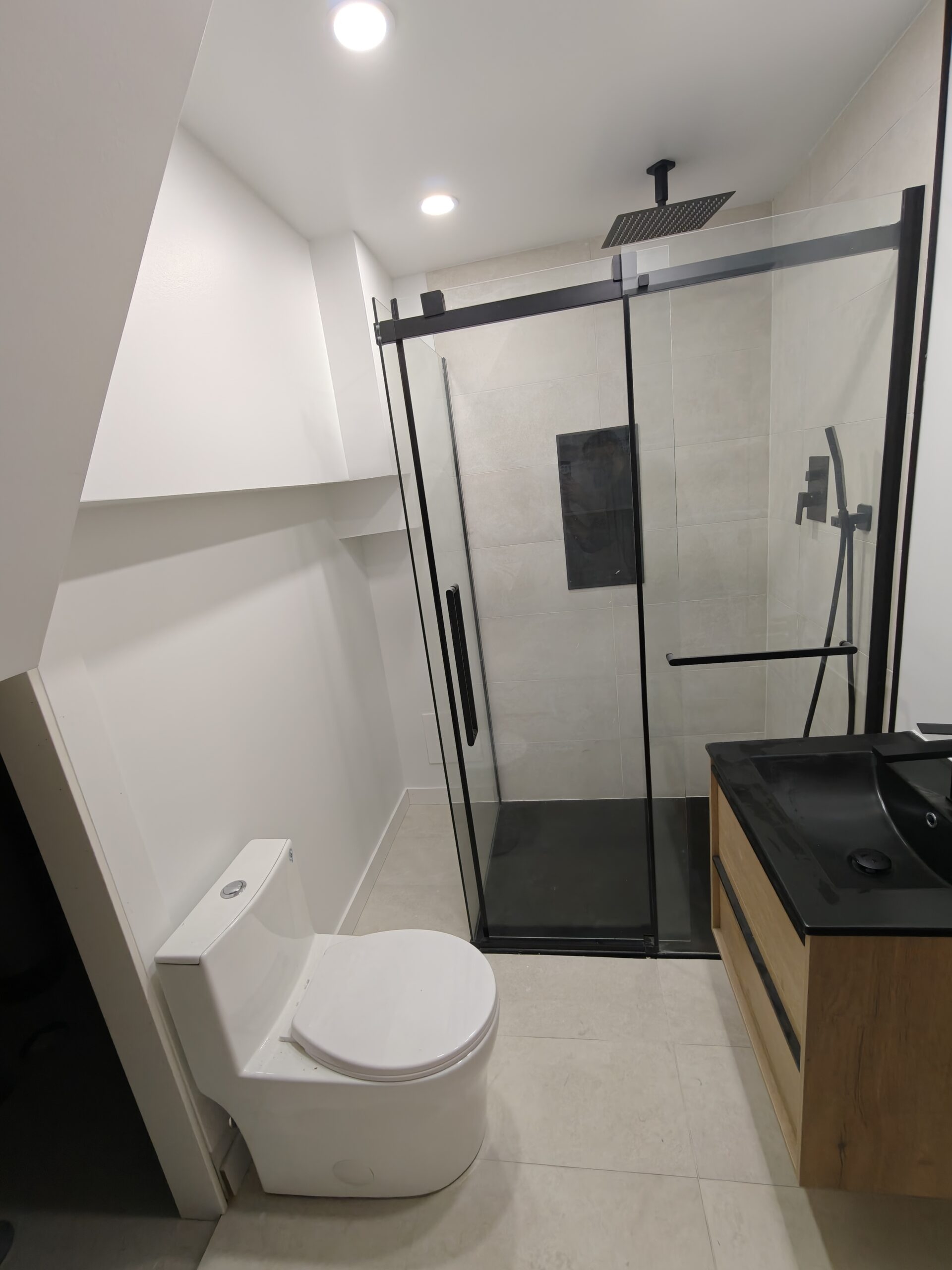 Small bathroom renovation Montreal - black glass shower enclosure floating vanity